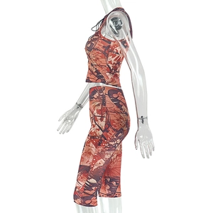 Side view of two-piece orange abstract print set with sleeveless crop top and leggings