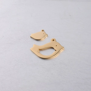 Detailed view of large and small golden bird stainless steel pendants for DIY jewelry