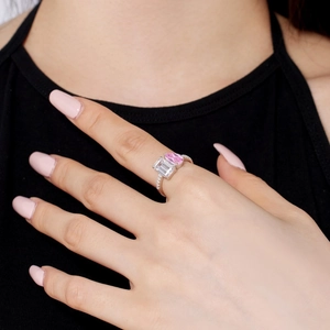 Macro detail of S925 silver ring featuring a pear-cut pink and emerald-cut clear stone