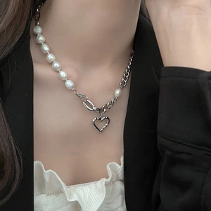 Elegant pearl and silver chain necklace featuring a hollow heart pendant for women