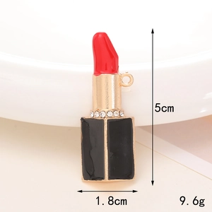 Macro shot of lipstick pendant charm with red enamel and sparkling crystal accents