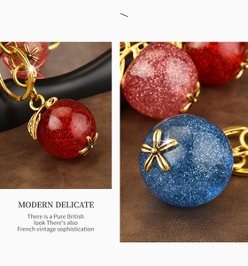Detailed macro view of vintage gold floral metal accents on resin ball keychain charm