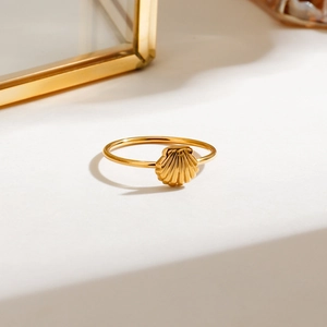 Macro shot of gold shell ring with detailed texture on minimalist background