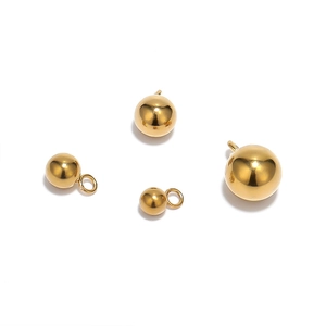 Polished gold stainless steel ball pendants with loops in multiple sizes on white base