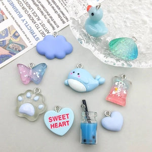 Assorted cute resin cartoon pendants including whale and shell with metal hanging loops