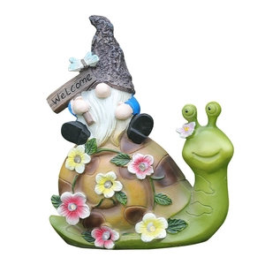 Solar powered gnome riding snail garden statue with glowing LED flowers and Welcome sign