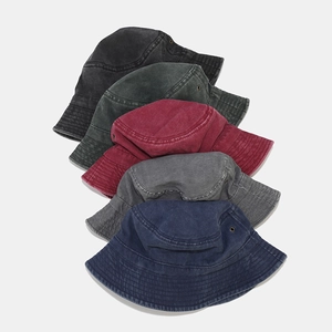 Detail of washed cotton bucket hats in five colors with metal eyelets and vintage texture