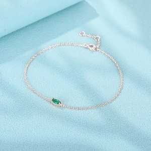 Detailed macro view of S925 silver bracelet featuring marquise-cut green zircon stone