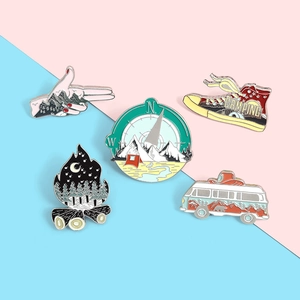 Detailed view of a 5-piece enamel pin set featuring outdoor hiking and camping themes