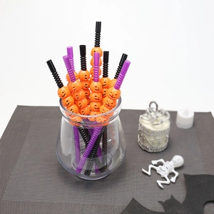 Halloween decorative pumpkin straws in orange and black for party table settings