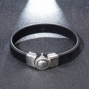 Men's woven black leather bracelet with silver stainless steel magnetic clasp on black surface