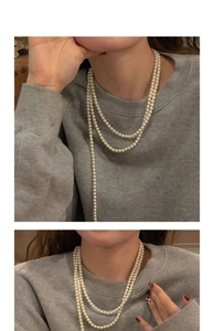Detail view of a layered pearl necklace showing elegant draping and soft pearlescent luster