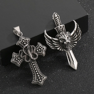 Gothic lion head and winged cross pendants in vintage silver finish on black background