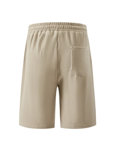 Close-up of corduroy fabric texture and back pocket on men's casual beige shorts