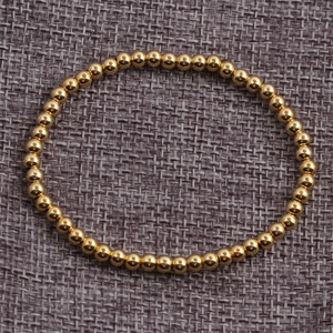 Polished gold beaded elastic bracelet with high shine finish for women everyday wear