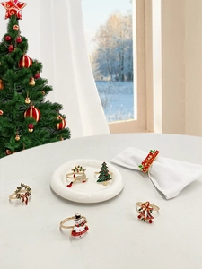 Close-up of festive metal napkin rings featuring Christmas tree and reindeer motifs