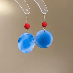 Boucles d'oreilles en acrylique marbré avec perles rouges et crochets en métal doré