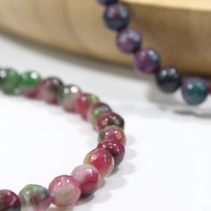Macro shot of colorful tourmaline crystal beaded bracelet with natural textures
