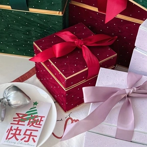 Elegant festive gift boxes with silk bows and white polka dots for Christmas or Halloween
