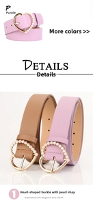 Close-up detail of heart-shaped alloy buckle with pearls on purple and brown leather belts