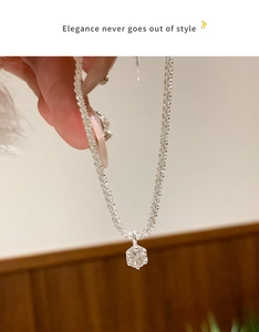 Close-up of elegant silver star chain necklace with hexagonal sparkling zircon pendant