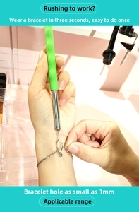 Detail view of bracelet helper tool fastening a clasp on a wrist for 1mm link sizes