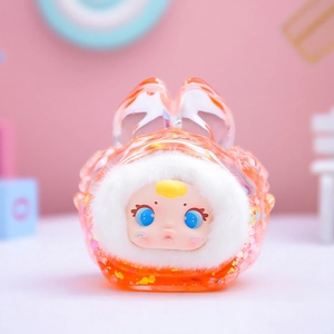 Macro shot of an orange translucent plush toy figure with cute bunny ears and glitter detail