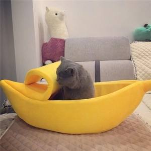 Cozy banana-shaped pet bed made of soft yellow plush fabric for small cats and dogs