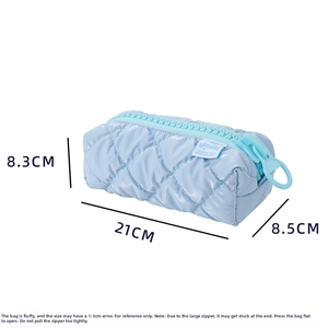 Macro view of blue quilted pencil case with oversized zipper and 21cm length dimensions