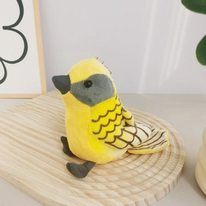Macro view of plush yellow bird keychain showing soft texture and wave wing patterns