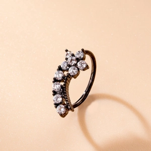 Macro detail of black plated nose ring featuring eight shimmering round zirconia stones
