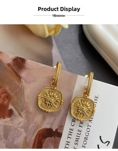 Detail view of vintage matte gold sunburst earrings with elegant floral relief textures
