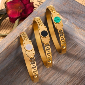 Retro titanium steel gold bangles with white shell and colorful stone inlays on wood