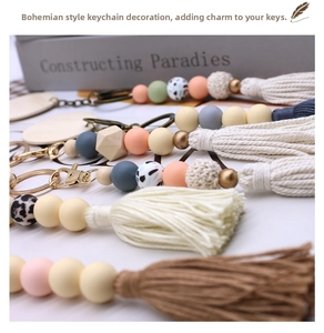 Close-up of bohemian keychains with colorful silicone beads, wood beads and long cotton tassels