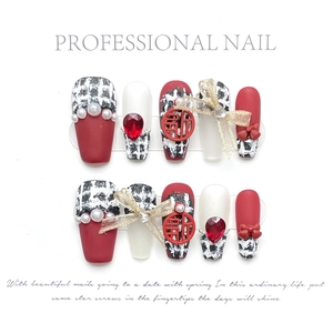 Handmade red tweed press-on nails with pearls, heart gems, and gold bow decorations