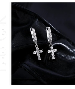 Macro view of S925 sterling silver cross drop earrings with sparkling pavé setting