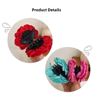 Detail of layered chiffon fabric flower hair claws in red, cyan, and pink colors