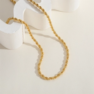 Macro detail of high-quality 18K gold-plated twisted rope chain with a metallic texture
