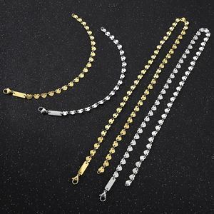 Detail of heart-shaped link necklaces and bracelets with rectangular tags in gold and silver