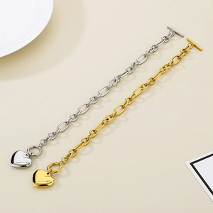 Detailed view of heart pendant bracelets in gold and silver finish with OT toggle clasps