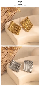 Detailed view of gold and silver rectangular earrings with elegant wavy ripple textures