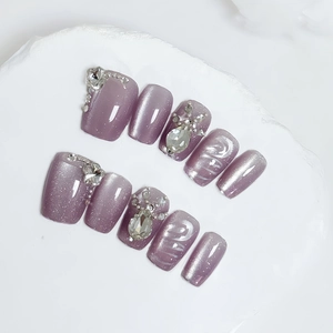 Handmade cat eye press-on nails in lilac purple with rhinestones and flower crystals