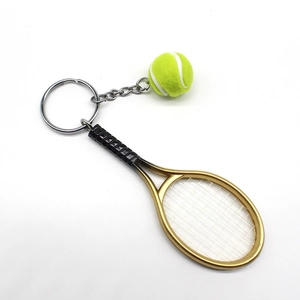 Tennis racket and yellow felt ball keychain with metal chain on a white background