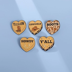Five heart-shaped enamel pins featuring western cowboy icons and yeehaw typography