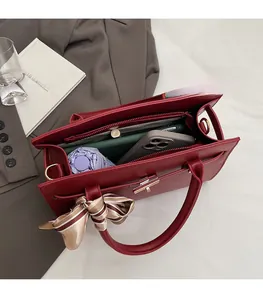 Top view of open red leather handbag showing large capacity for umbrella and phone