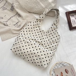 Polka dot canvas tote bag shown in a cozy home setting with French decor accents