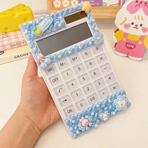 Detail of DIY calculator with blue cream glue, pearls and cute cartoon charms