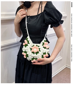 Detail of handmade crochet puff flower crossbody bag with 3D floral texture and strap