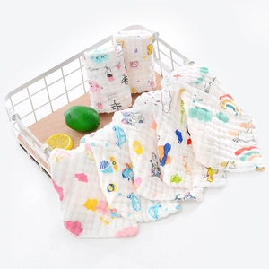 Close-up of six-layer cotton muslin baby towels with colorful cartoon prints in a basket