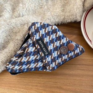 Detailed close-up of handmade triangular hair claw with blue plaid fabric and buttons